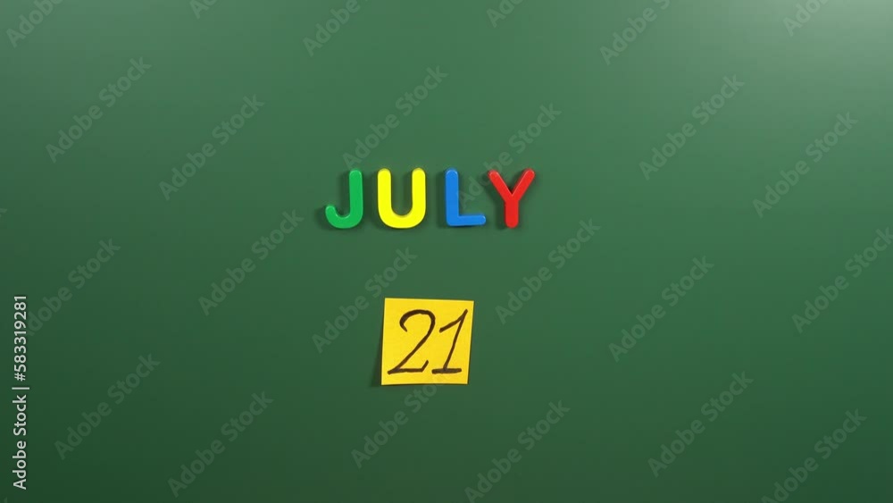 Hand sticking a sticker 21 July calendar day on school board. 21 date of July. Twenty first day of July. 21th date number. 21 day calendar. Twenty one date. Belgian National, National Junk Food Hand sticking a sticker 21 July calendar day on school board. 21 date of July. Twenty first day of July. 21th date number. 21 day calendar. Twenty one date. Belgian National, National Junk Food
