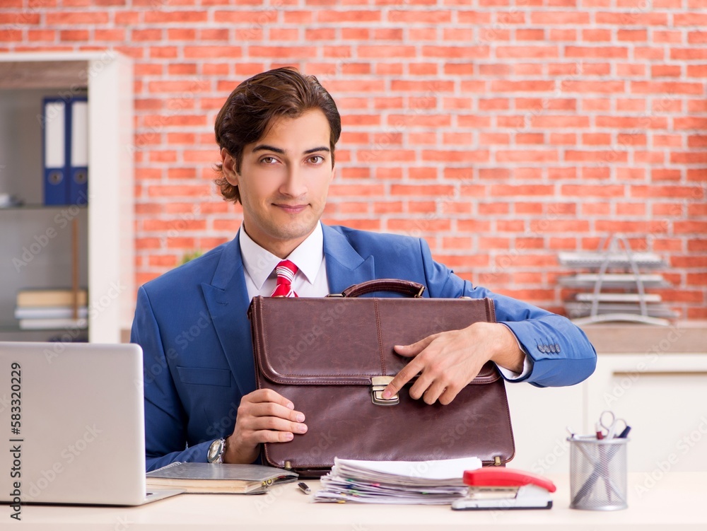 Young handsome employee working in the office Young handsome employee working in the office