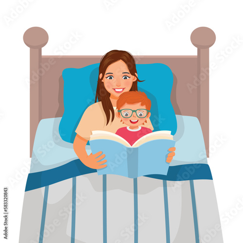 Young mother reading bedtime story book to her son in the bed