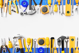 3D illustration of a white field for design and various tools around a screwdriver, ratchet, hammer, pliers, screws, etc. for handicraft. Various working tools. Building, building, renovation concept.