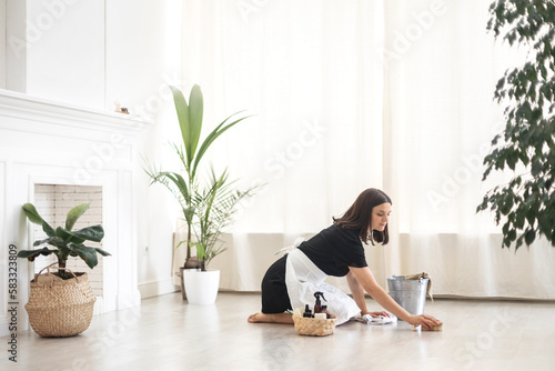 House keeping concept. Woman wiping floor. Woman doing chores at home.