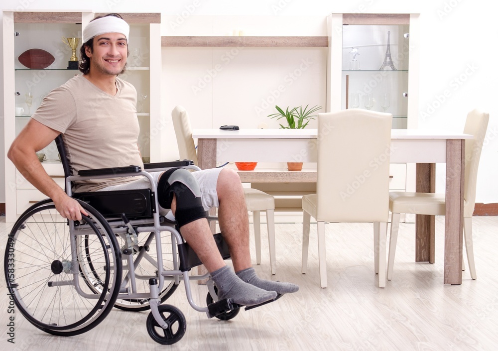 Injured young man doing exercises at home Injured young man doing exercises at home