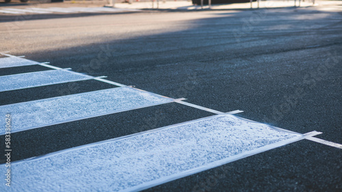 Process of making new road surface markings with a line striping machine, workers improve city infrastructure, demarcation marking of pedestrian crossing with a hot melted paint on asphalt pavement