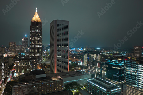 Night urban landscape of downtown district of Atlanta city in Georgia, USA. Skyline with brightly illuminated high skyscraper buildings in modern american megapolis photo