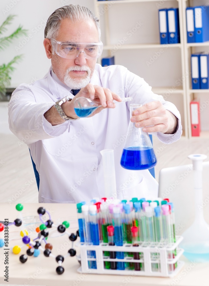 Old male chemist working in the lab Old male chemist working in the lab