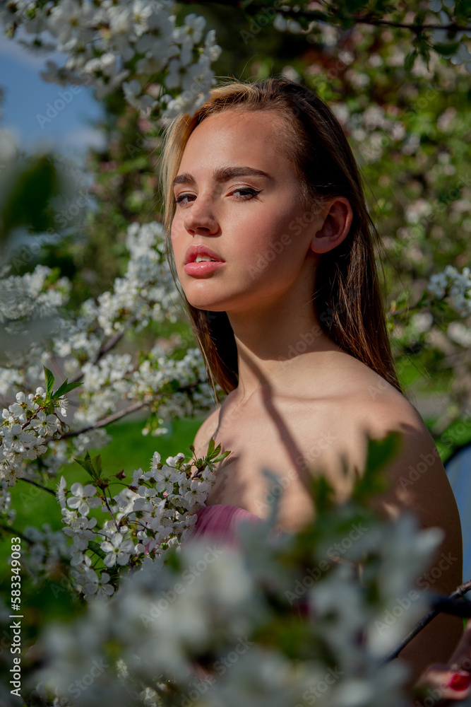 Portrait of an Asian girl in a blooming garden. Flowering trees, traditional asians, travel, seasonal april background. Portrait of an Asian girl in a blooming garden. Flowering trees, traditional asians, travel, seasonal april background.
