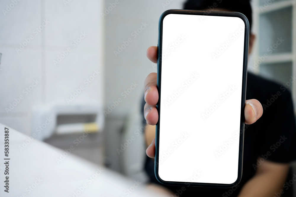 Smart phone with white screen background in toilet, restroom or WC. Closeup of hands using mobile phone with blank copy space screen, empty white screen for advertising text in toilet Smart phone with white screen background in toilet, restroom or WC. Closeup of hands using mobile phone with blank copy space screen, empty white screen for advertising text in toilet