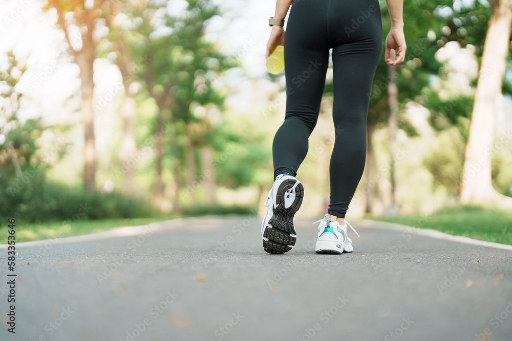 woman jogging and walking on the road at morning, Young adult female in sport shoes running in the park outside, leg muscles of Athlete. Exercise, wellness, healthy lifestyle and workout concepts woman jogging and walking on the road at morning, Young adult female in sport shoes running in the park outside, leg muscles of Athlete. Exercise, wellness, healthy lifestyle and workout concepts