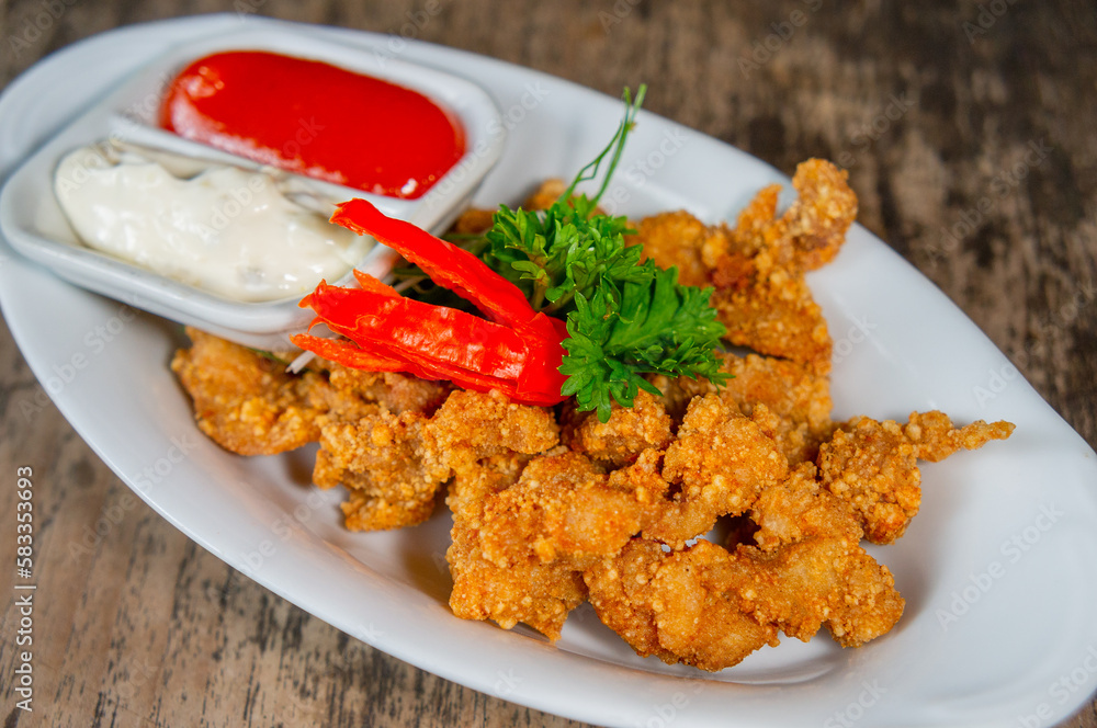 Delicious Fried Crispy Chicken Made from Breast and Skin's Chicken on White-Oval Plate Delicious Fried Crispy Chicken Made from Breast and Skin's Chicken on White-Oval Plate