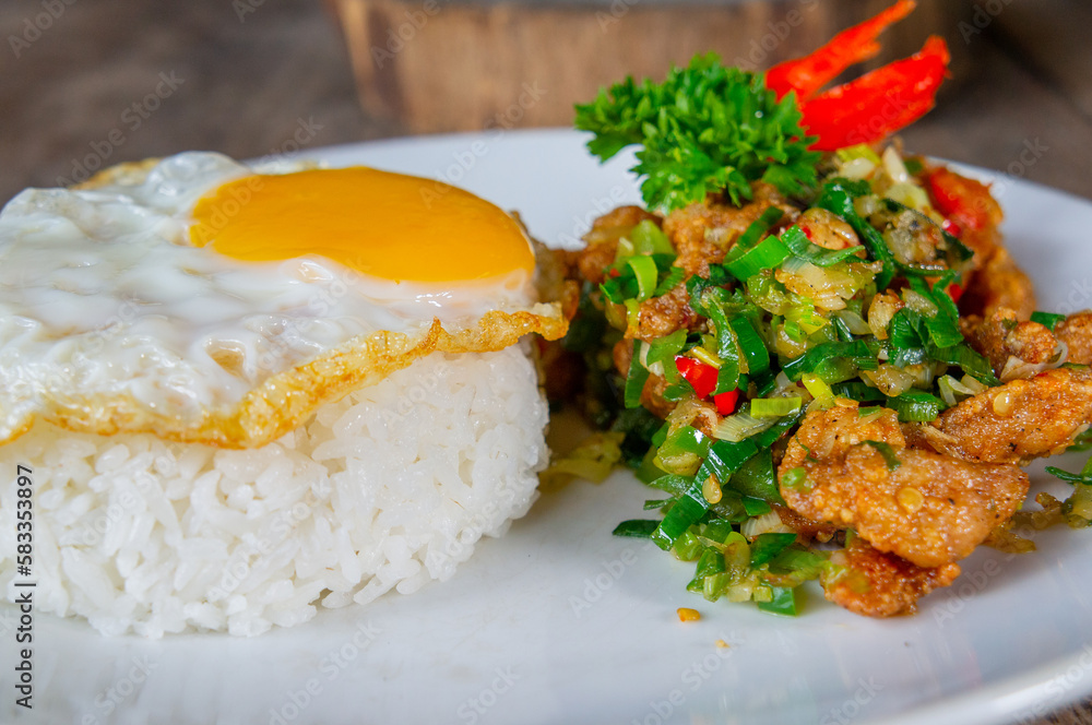 Delicious Salt Pepper Chicken or Ayam Cabe Garam with Fried Egg on Steam Rice Delicious Salt Pepper Chicken or Ayam Cabe Garam with Fried Egg on Steam Rice