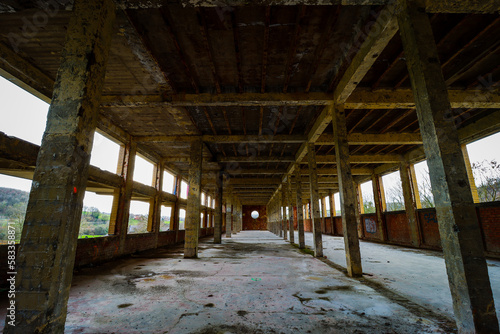 big hall with columns in an abandoned factory building