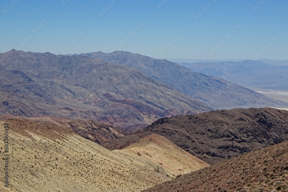Various colored layers of rock, the result of millions of years of sediment collection, are visible from Zabriskie Point in Death Valley National Park