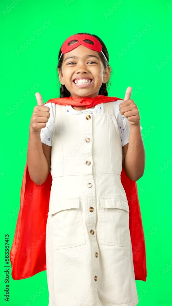 Little girl, superhero and thumbs up on green screen for success against a studio background. Portrait of happy adorable child or kid in hero cosplay showing thumb emoji, yes sign or like on mockup Little girl, superhero and thumbs up on green screen for success against a studio background. Portrait of happy adorable child or kid in hero cosplay showing thumb emoji, yes sign or like on mockup