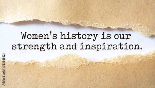 Women's history is our strength and inspiration. Words written under torn paper.