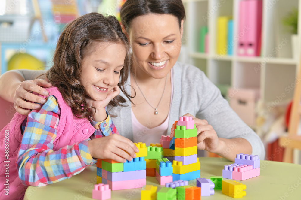 Curly little girl and her mother playing Curly little girl and her mother playing