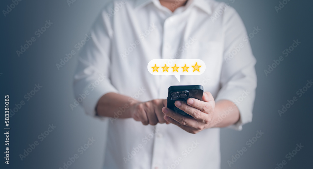 Customer holding smartphone give a five star rating for feedback review satification service, Concept of service rating, Experience and Feedback for business satisfaction survey. Customer holding smartphone give a five star rating for feedback review satification service, Concept of service rating, Experience and Feedback for business satisfaction survey.
