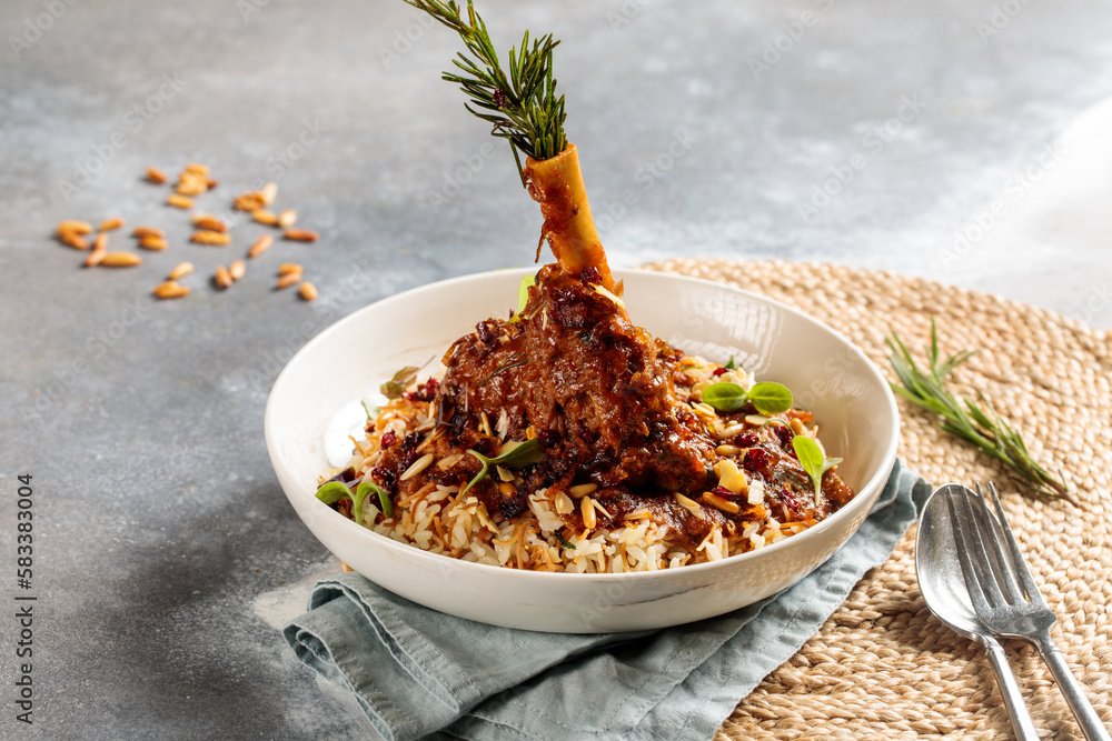 Lamb Shank biryani rice served in dish isolated on table top view of arabic breakfast Stock
