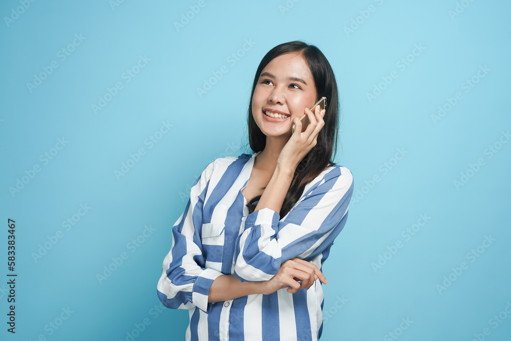 Happy Asian woman talking on smartphone with smile isolated on background Happy Asian woman talking on smartphone with smile isolated on background