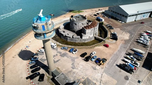 National coast watch  radar tower and Calshot castle artillery fort on Calshot spit orbiting aerial view photo