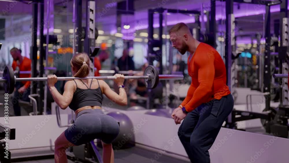 The trainer shows you how to properly perform exercises on the simulator in the gym. Fitness training and an active lifestyle. The girl goes in for sports and trains her legs with a trainer. The trainer shows you how to properly perform exercises on the simulator in the gym. Fitness training and an active lifestyle. The girl goes in for sports and trains her legs with a trainer.