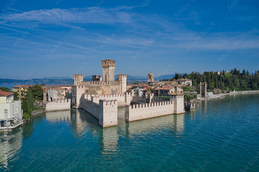 Italian castles Scaligero on the water. Top view of the 13th century castle. Popular travel destination on Lake Garda in Italy. Scaligero Castle drone view. Sirmione top view.