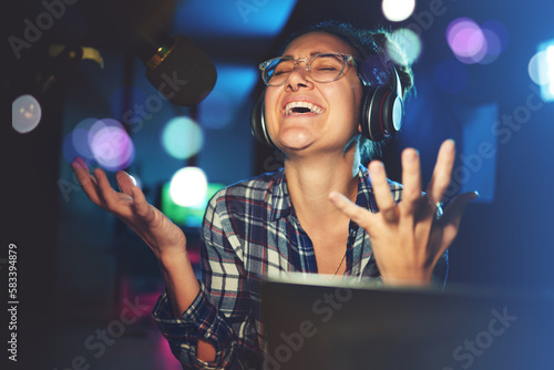 Radio DJ, headphone and microphone, woman is excited with singing or talking, broadcast media and announcement. Female in studio booth, recording and happiness with smile, excitement and carefree