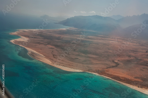 View of the deserted coast of the island from the window of the plane. Yemen. Socotra island.