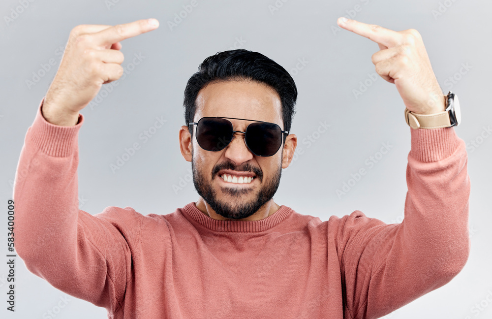 Portrait, rude and man with anger, middle finger and frustrated against grey studio background. Face, male and guy with offensive hand gesture, aggressive and conflict with expression and disrespect Portrait, rude and man with anger, middle finger and frustrated against grey studio background. Face, male and guy with offensive hand gesture, aggressive and conflict with expression and disrespect