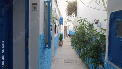 Labyrinth of alleyways in old city of Tangier in Morocco, walk through narrow street