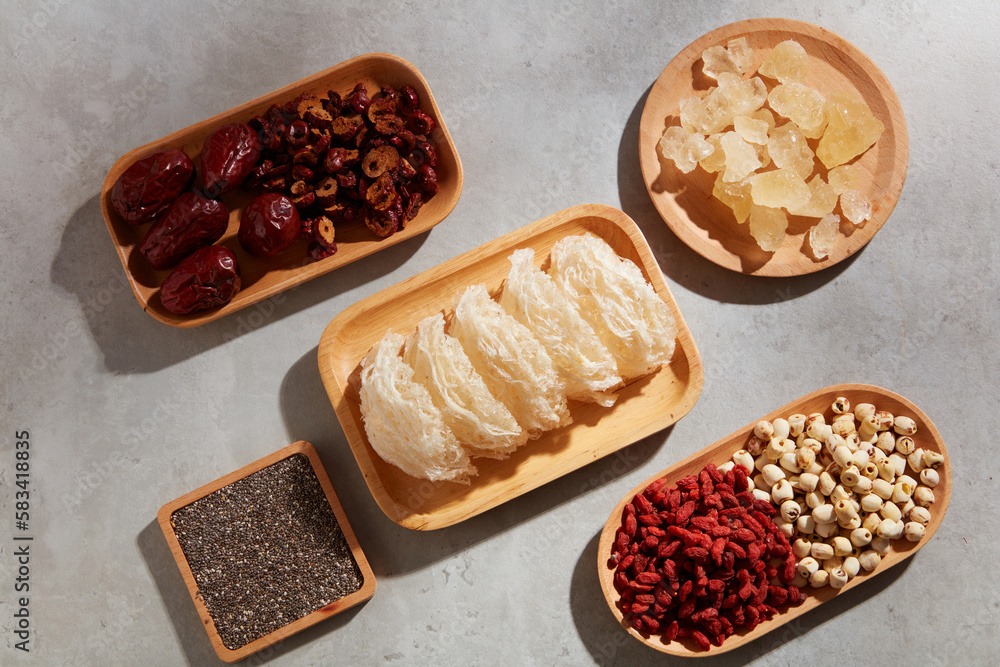 Edible bird’s nest, chia seeds, jujube, rock sugar, dried goji berries and lotus seeds placed on wooden dishes. Expensive foods for healthcare Edible bird’s nest, chia seeds, jujube, rock sugar, dried goji berries and lotus seeds placed on wooden dishes. Expensive foods for healthcare