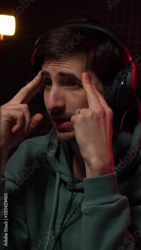 Thoughtful cybersport gamer playing video game on computer. Vertical video