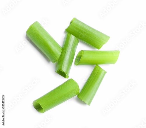 Pieces of fresh green onion on white background, top view
