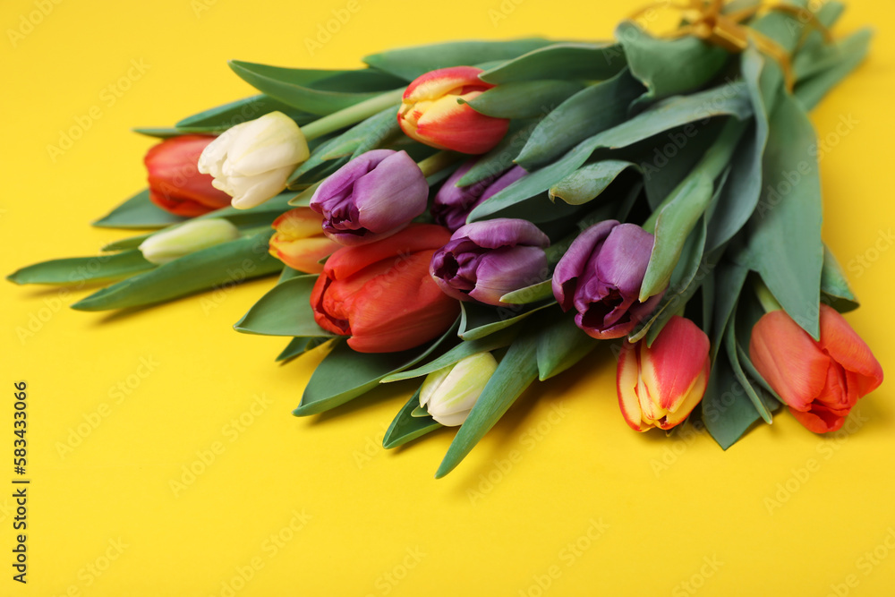 Bunch of beautiful tulips on yellow background Bunch of beautiful tulips on yellow background