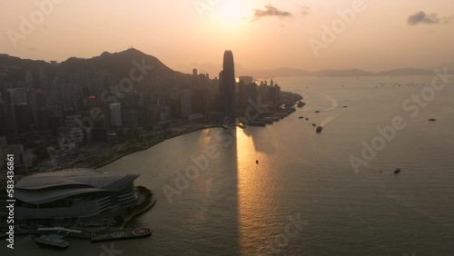 Epic Sunset Behind The International Finance Center Casting a Shadow of the Building in Water, Wide Angle Cinematic Drone Shot photo