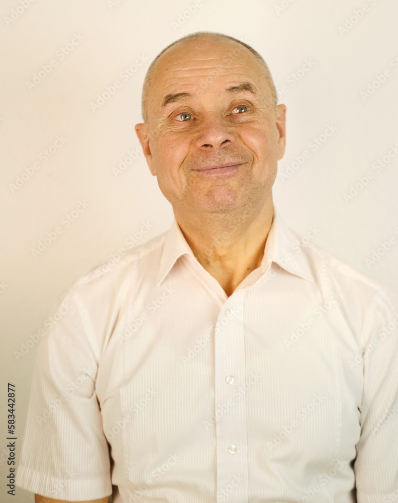Fototapeta premium close up funny male face, bald mature man 60 years old, senior looks satisfied with life, aging skin, wrinkles, concept of human health, optimism in adulthood, midlife crisis