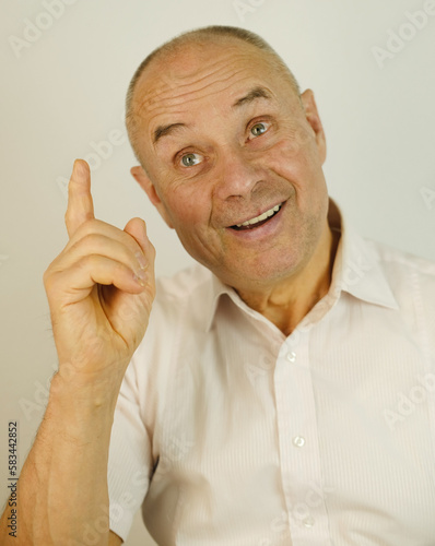 close up funny male face, bald mature man 60 years old, senior looks satisfied with life, pointing fingers, aging skin, wrinkles, concept of human health, optimism in adulthood, midlife crisis photo