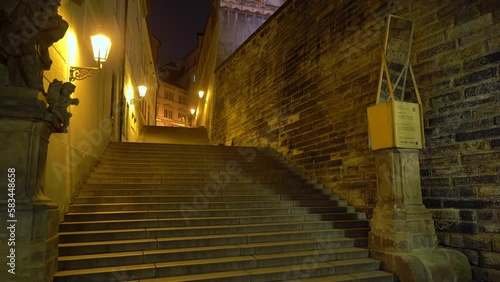 Walking towards the Radnicke steps in Ke Hradu street in Prague at night photo