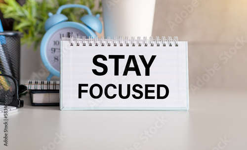 Stay focused text on blank with blurred background. Business concept to inform audience to stay focused.