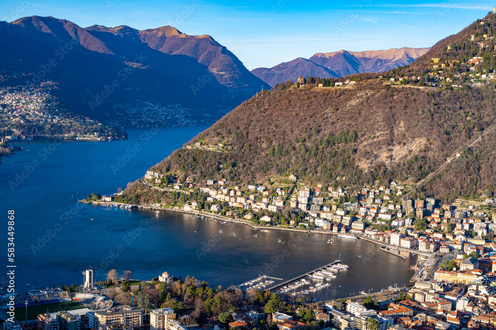 The city of Como, the lake, the lakeside promenade, the buildings, photographed from above.

