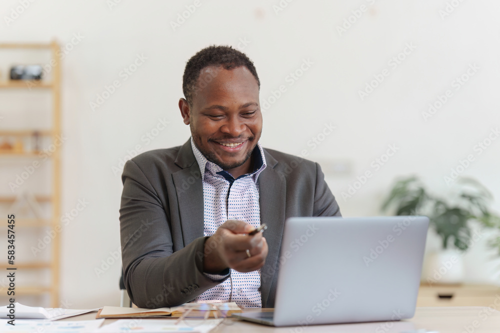 Smiling American African Banker or Accountant video call with client and makes financial report and studies annual figures, analyzes profits Smiling American African Banker or Accountant video call with client and makes financial report and studies annual figures, analyzes profits