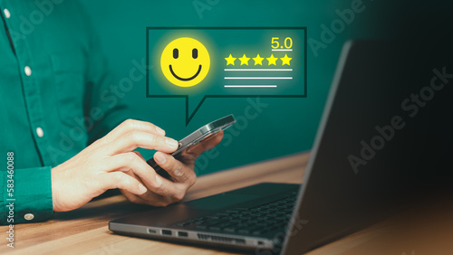 Customer using a mobile phone or smartphone in give rating to service experience assessment on application. Online customer review satisfaction feedback survey and testimonial.