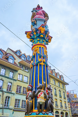 Kornhausplatz sqaure with public transport and medieval Kindlifresserbrunnen fountain, Bern, Switzerland photo