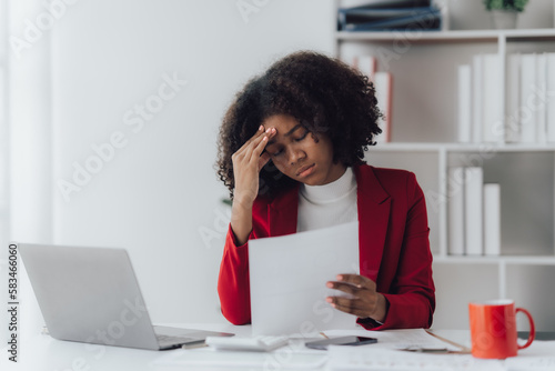 Young business woman worried about problem at work and stressed about problem with laptop computer.