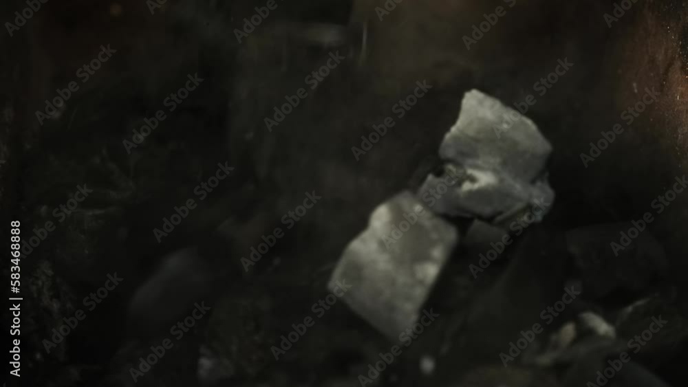 Charcoal is poured into the barbecue. Close-up Charcoal is poured into the barbecue. Close-up