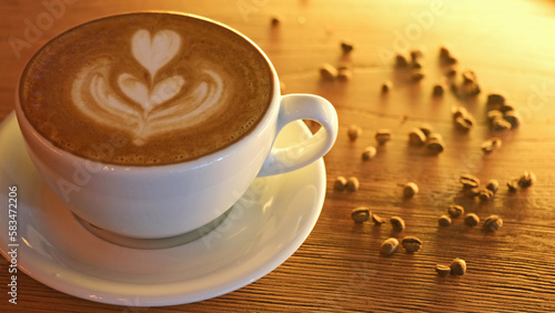 foamy latte with milk on wooden background