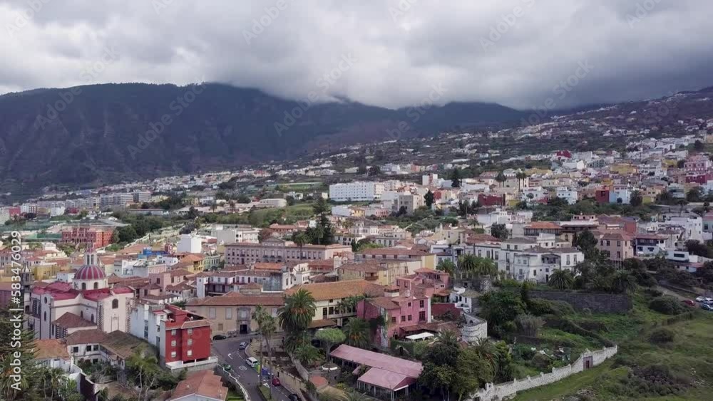drone fly above Puerto de la cruz little town in tenerife island with mountains landscape drone fly above Puerto de la cruz little town in tenerife island with mountains landscape
