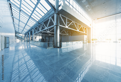 Obraz na płótnie Lobby and corridors of modern office building or airport, glass walls and reflective floor, natural light and flare w salonie