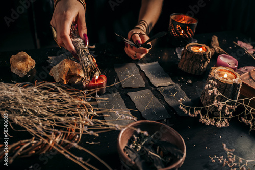 The woman is holding a smoking dry wood in her hands. Halloween