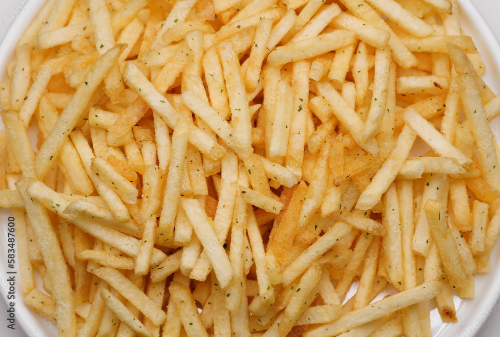 French fries background, closeup shot. Delicious potatoes with a golden fried crust. French fries background. Potato straw French fries background, closeup shot. Delicious potatoes with a golden fried crust. French fries background. Potato straw
