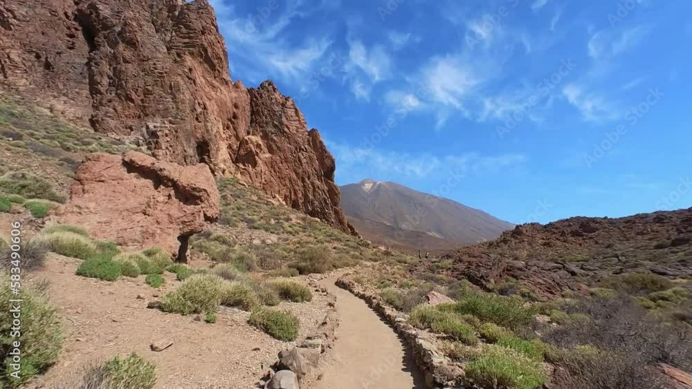 Man Hiking In Teide National Park, Volcanic Deserted Landscape, Mount Teide In The Background, Tenerife Island, Spain Man Hiking In Teide National Park, Volcanic Deserted Landscape, Mount Teide In The Background, Tenerife Island, Spain